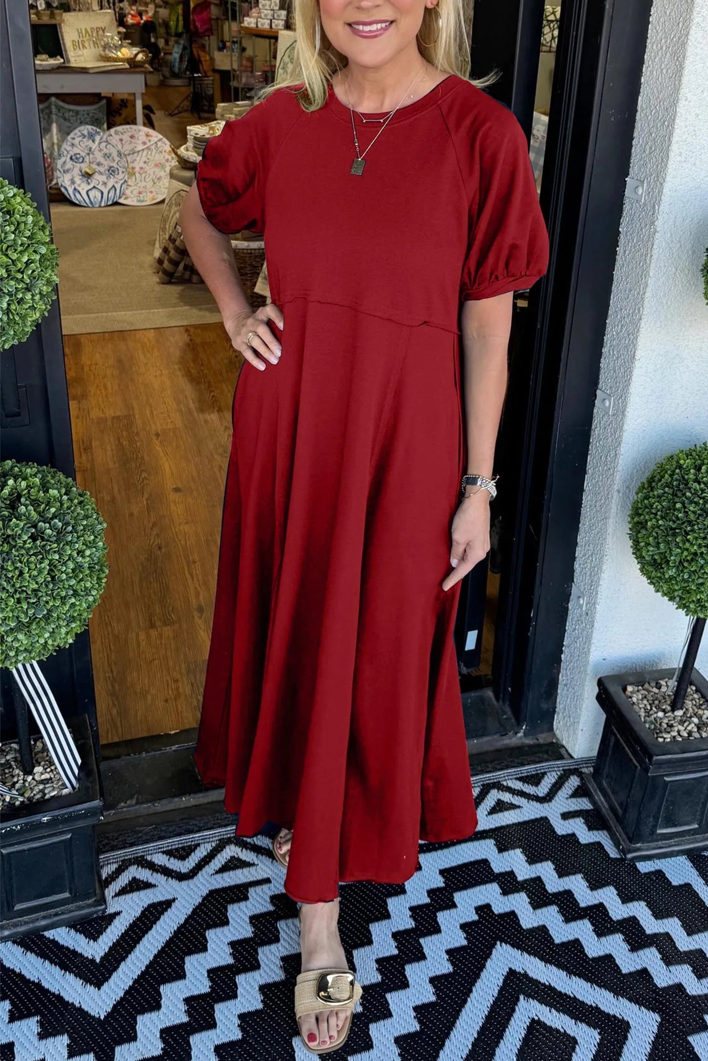 Overhead flat lay of the Rhys puff sleeve maxi dress, displaying the full design and solid color.
