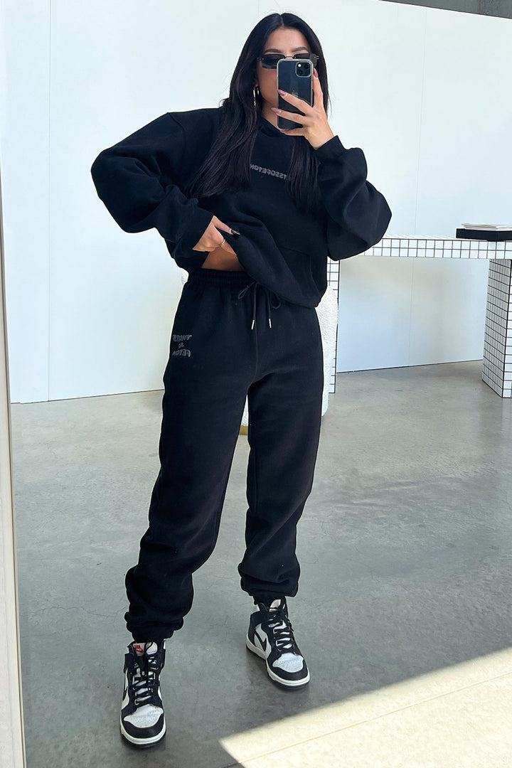 Women's black cropped hoodie with hood, long sleeves and contrasting back graphic text