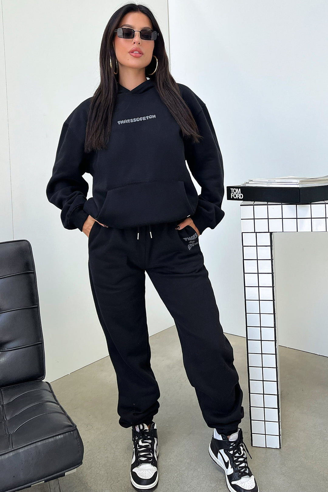 Women's black cropped hoodie with hood, long sleeves and contrasting back graphic text