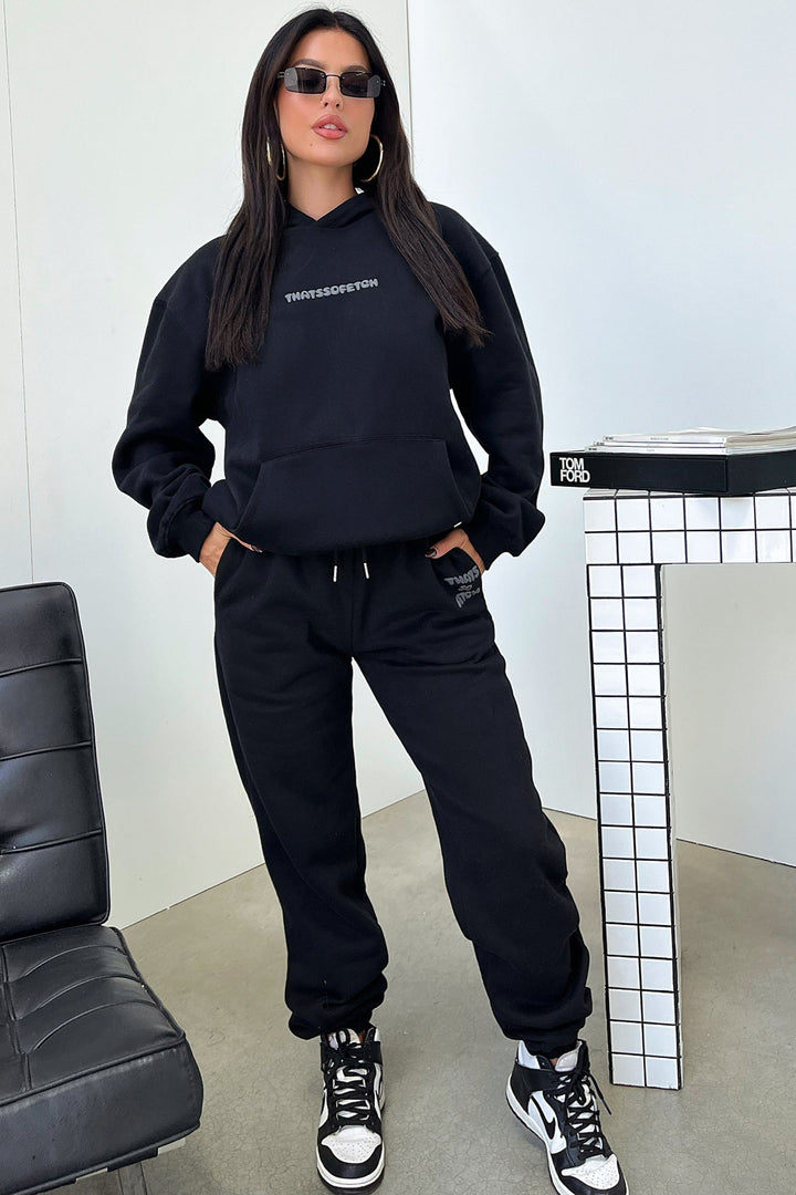 Women's black cropped hoodie with hood, long sleeves and contrasting back graphic text