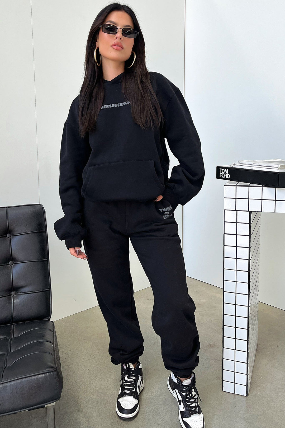 Women's black cropped hoodie with hood, long sleeves and contrasting back graphic text