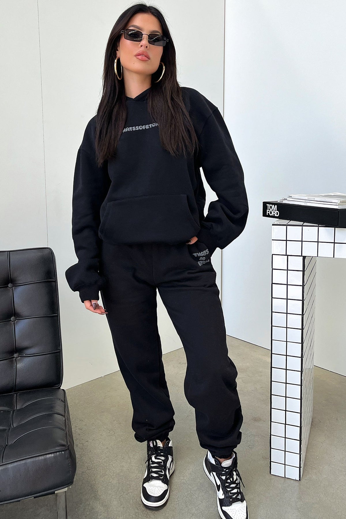 Women's black cropped hoodie with hood, long sleeves and contrasting back graphic text