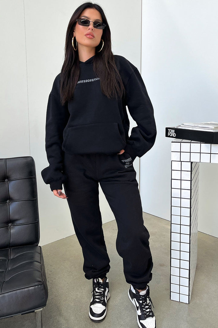 Women's black cropped hoodie with hood, long sleeves and contrasting back graphic text