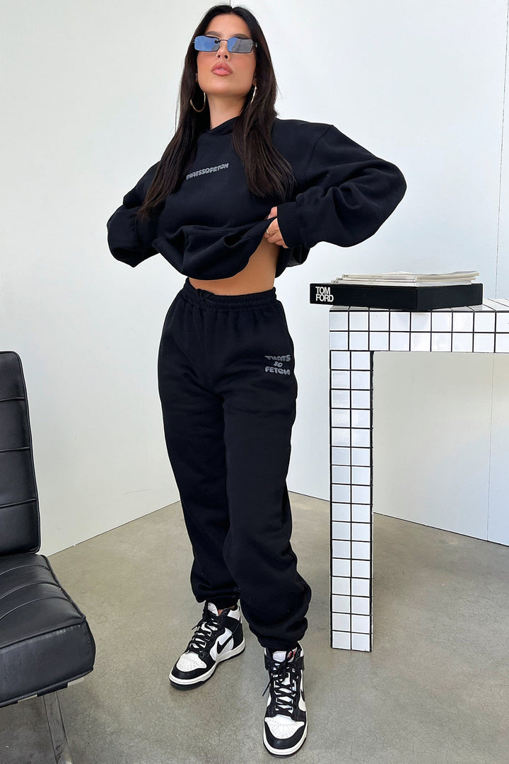 Women's black cropped hoodie with hood, long sleeves and contrasting back graphic text