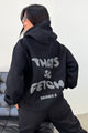 Women's black cropped hoodie with hood, long sleeves and contrasting back graphic text
