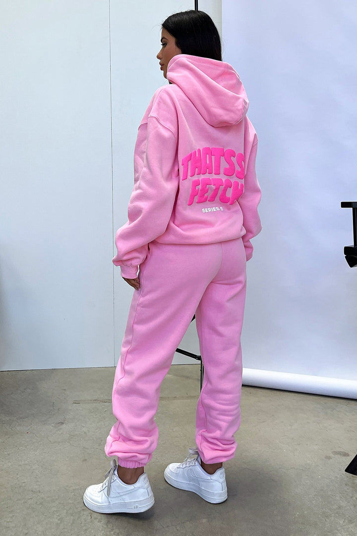 Women's pink cropped hoodie with long sleeves, front pouch pocket and chest text detail