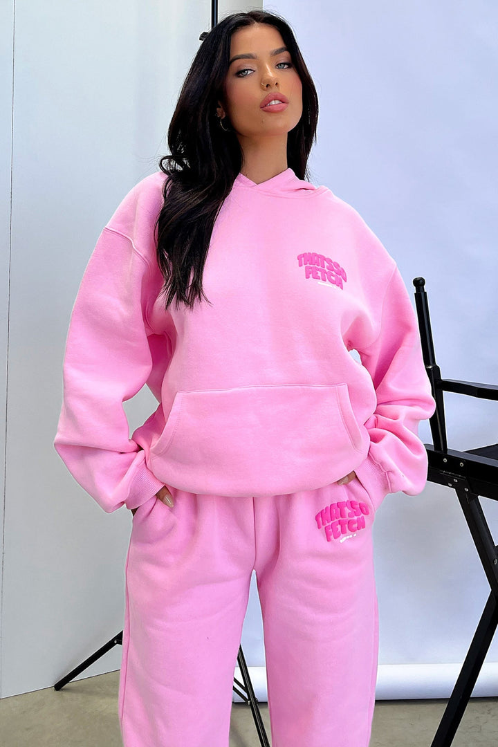 Women's pink cropped hoodie with long sleeves, front pouch pocket and chest text detail