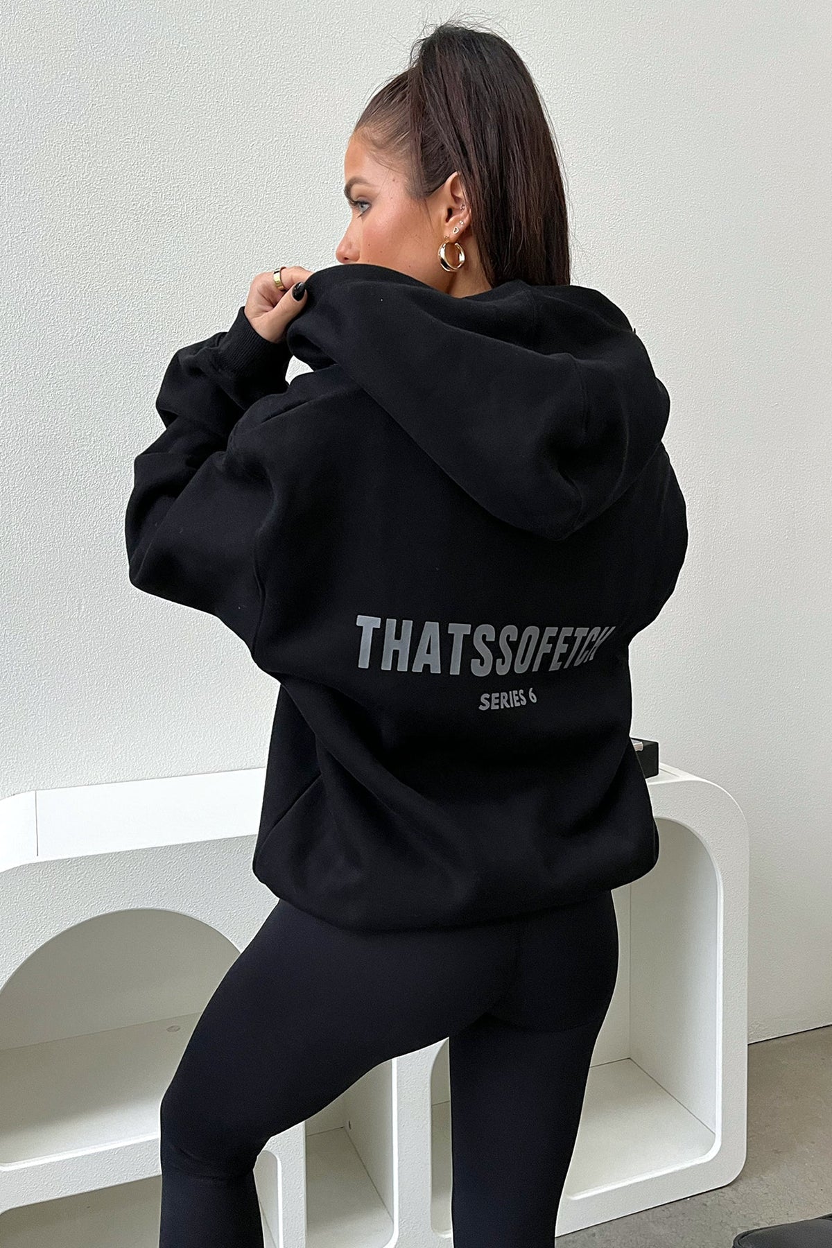 Women's black cropped zip-up hoodie with hood, long sleeves and chest lettering