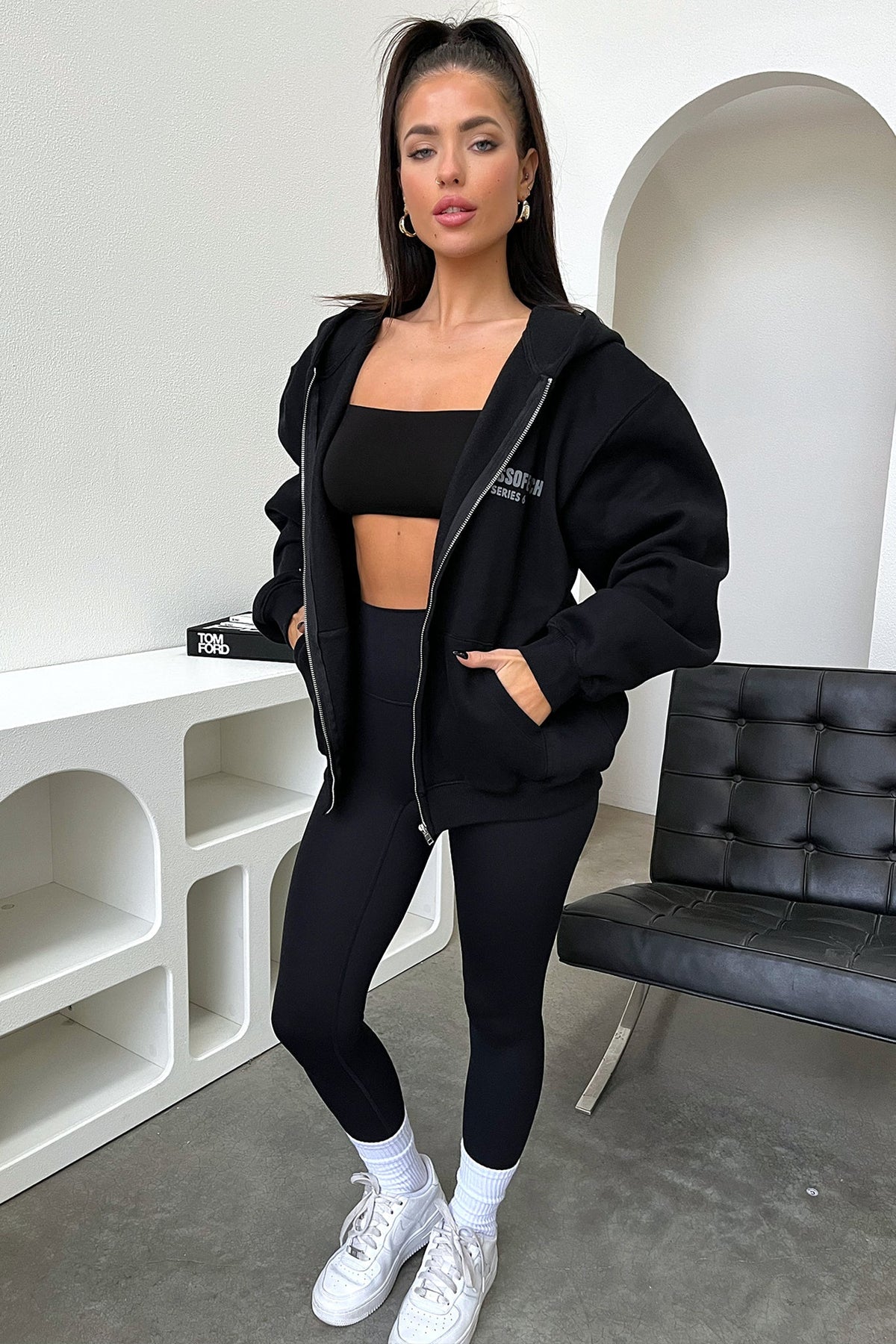Women's black cropped zip-up hoodie with hood, long sleeves and chest lettering