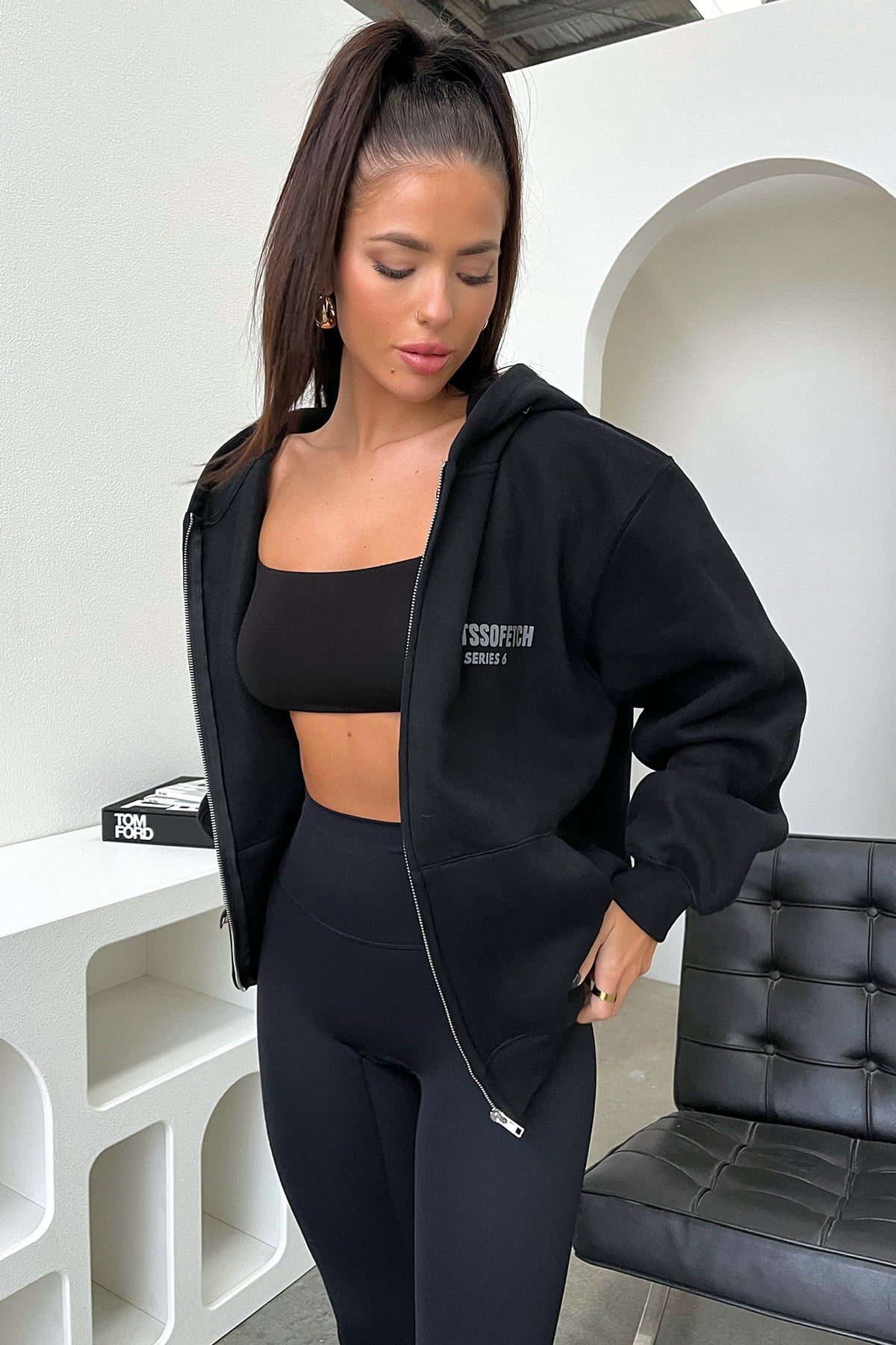 Women's black cropped zip-up hoodie with hood, long sleeves and chest lettering