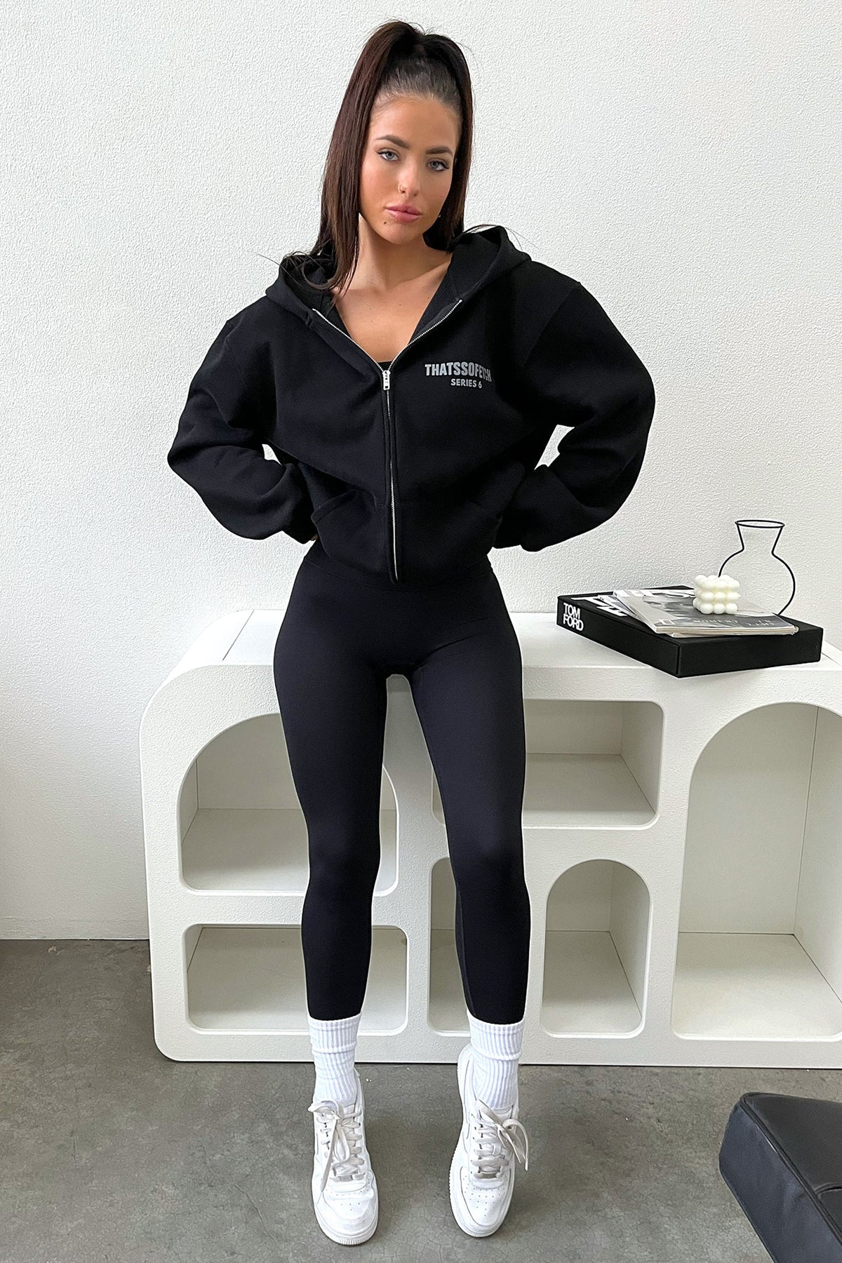 Women's black cropped zip-up hoodie with hood, long sleeves and chest lettering