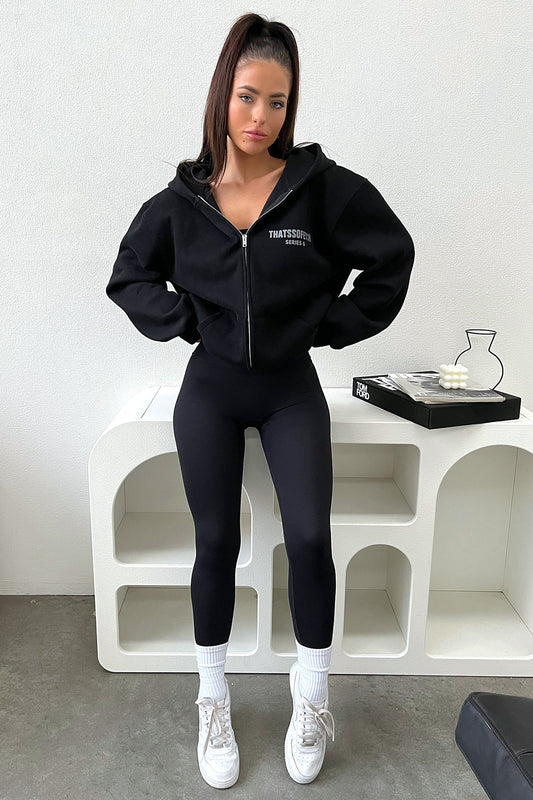 Women's black cropped zip-up hoodie with hood, long sleeves and chest lettering