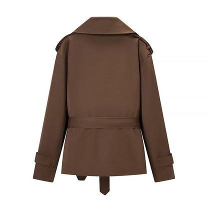 Women's brown cropped trench coat with wide lapels and tie belt