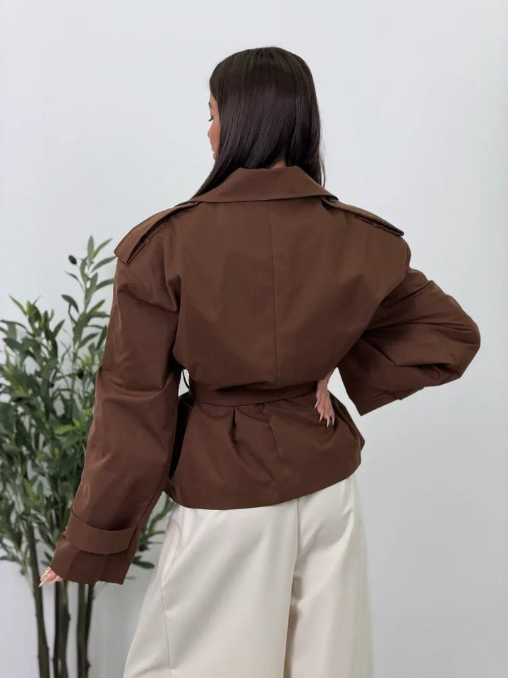 Women's brown cropped trench coat with wide lapels and tie belt