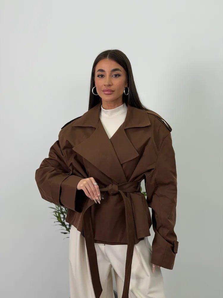 Women's brown cropped trench coat with wide lapels and tie belt