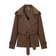 Women's brown cropped trench coat with wide lapels and tie belt