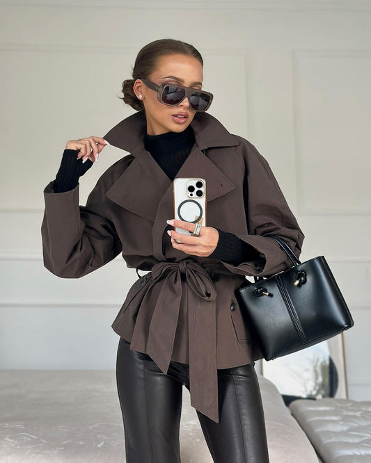 Women's short belted trench coat with wide lapels and long sleeves