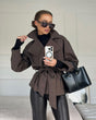 Women's short belted trench coat with wide lapels and long sleeves