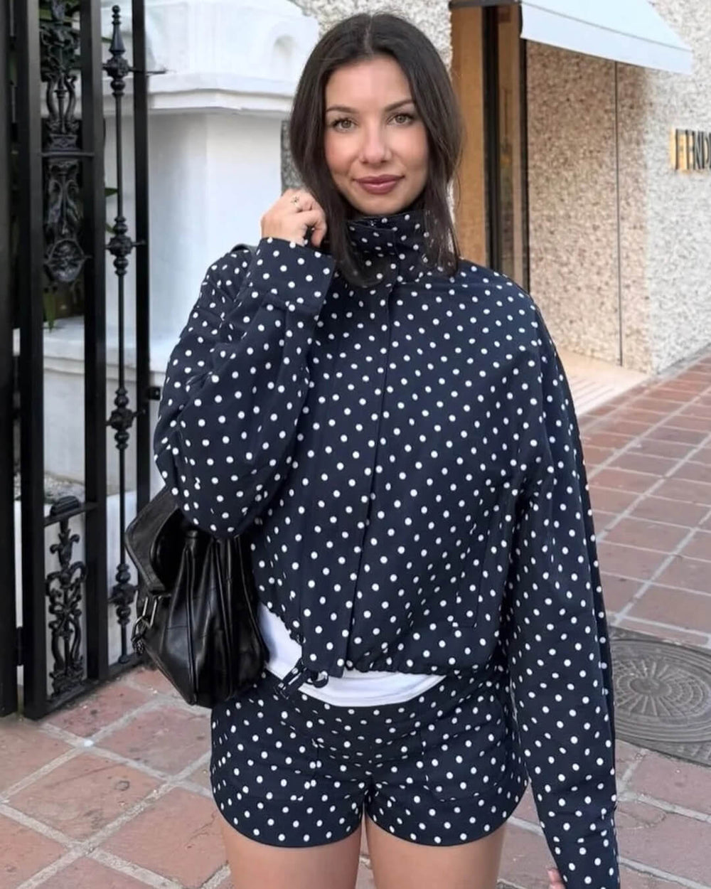 Women's polka dot cropped jacket with high neckline and long sleeves