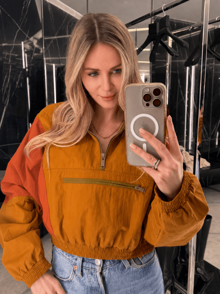 Women's color-block half-zip windbreaker jacket with high collar and zip pocket