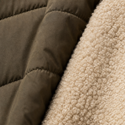 Women's long quilted hooded puffer coat shown in olive and navy