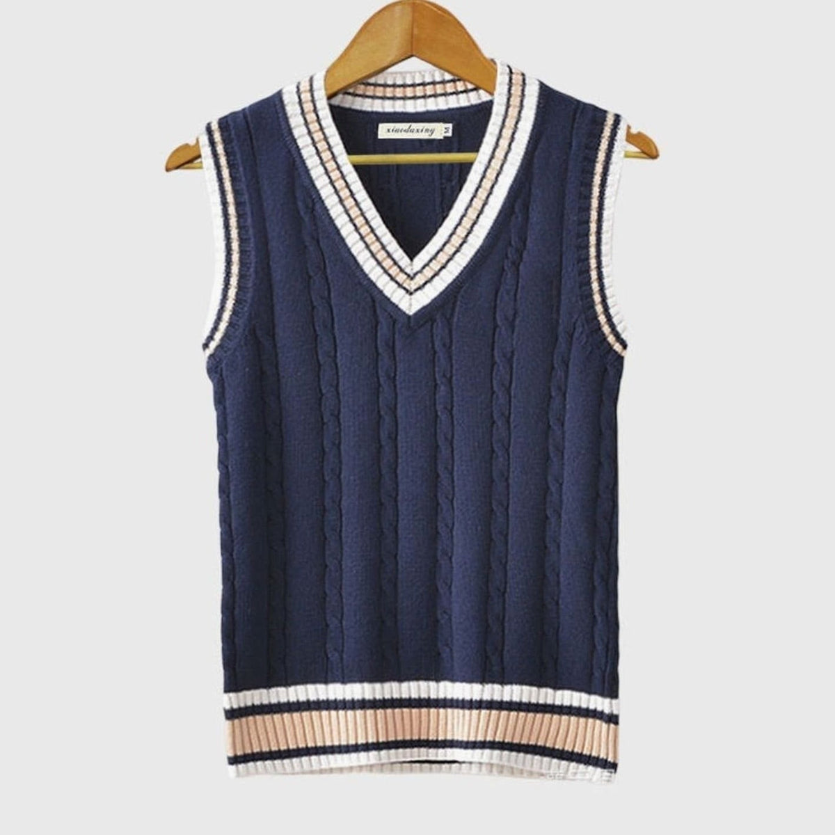 Women's sleeveless cable knit sweater vest with V-neck and ribbed contrast trim