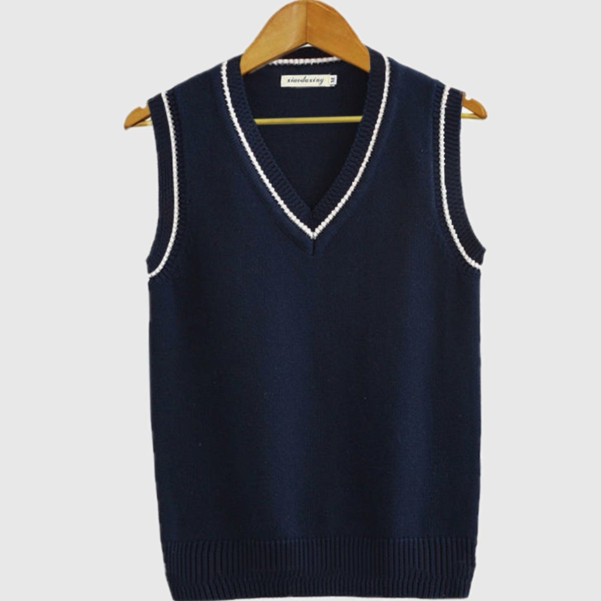 Women's sleeveless cable knit sweater vest with V-neck and ribbed contrast trim