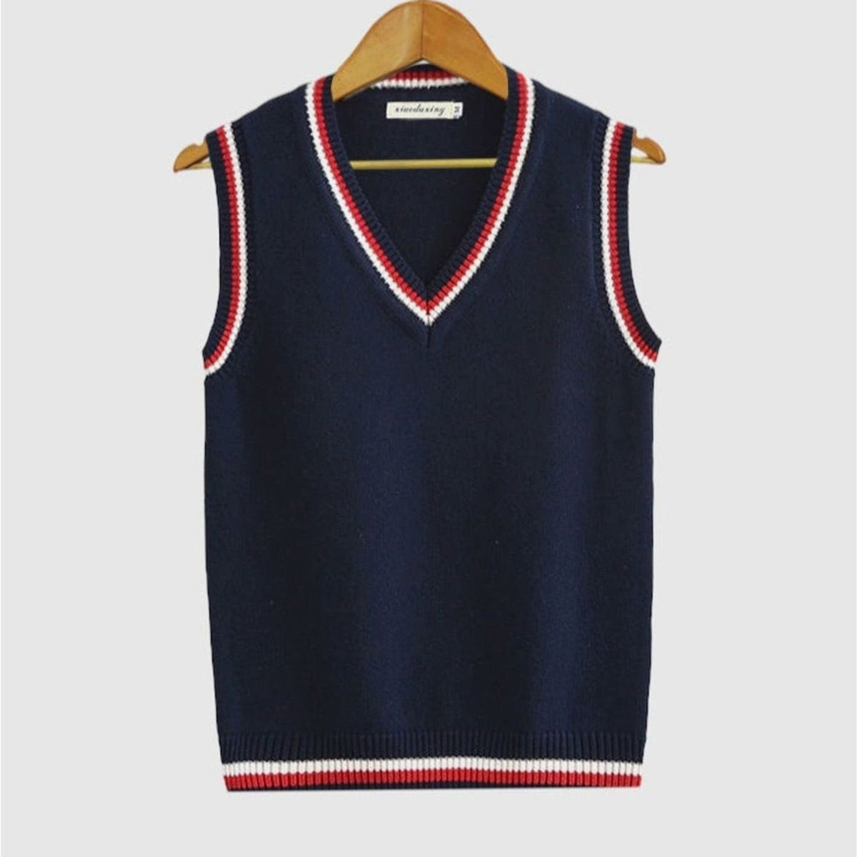 Women's sleeveless cable knit sweater vest with V-neck and ribbed contrast trim