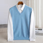 Women's sleeveless V-neck knit sweater vest layered over a white collared shirt