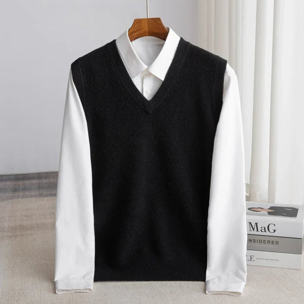 Women's sleeveless V-neck knit sweater vest layered over a white collared shirt