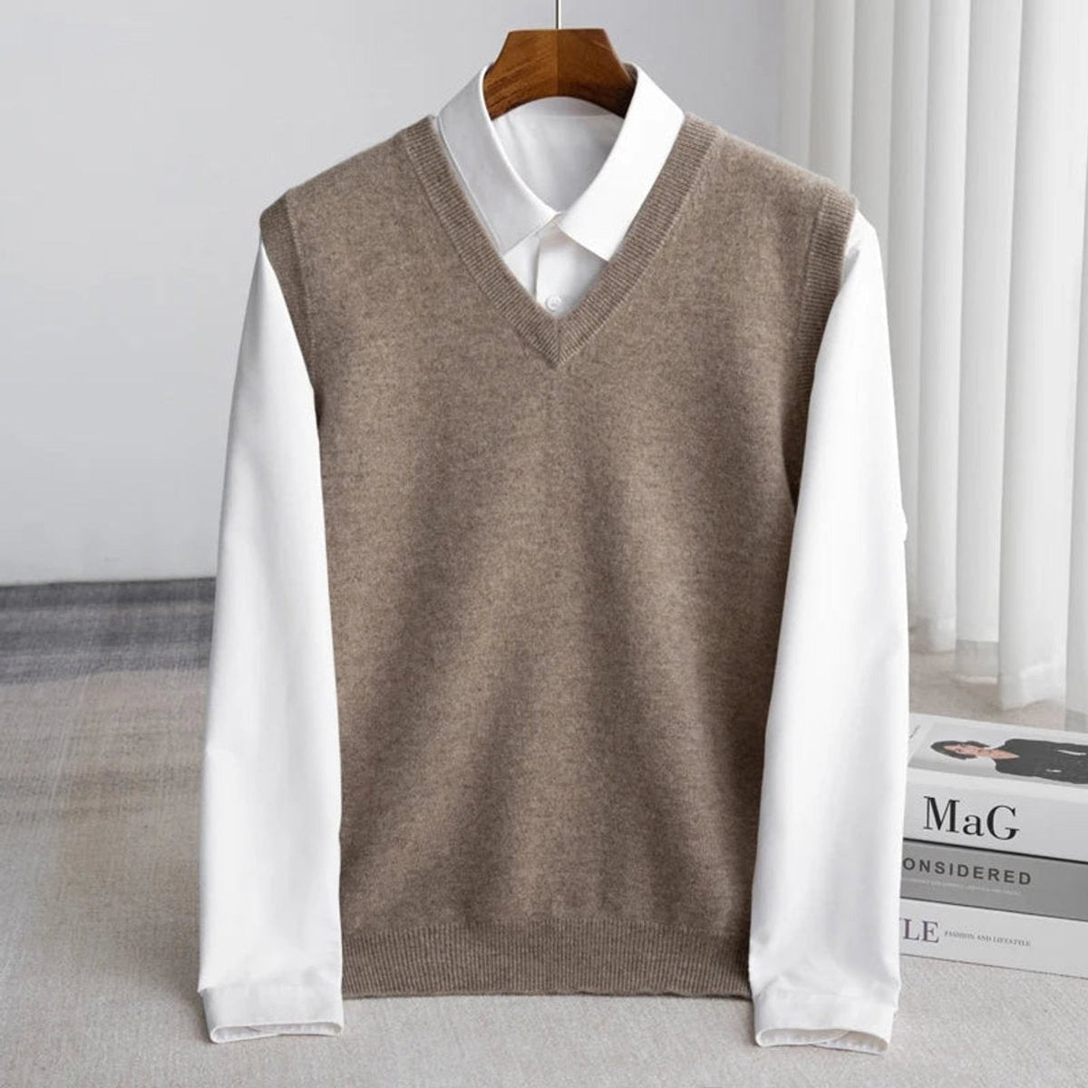 Women's sleeveless V-neck knit sweater vest layered over a white collared shirt