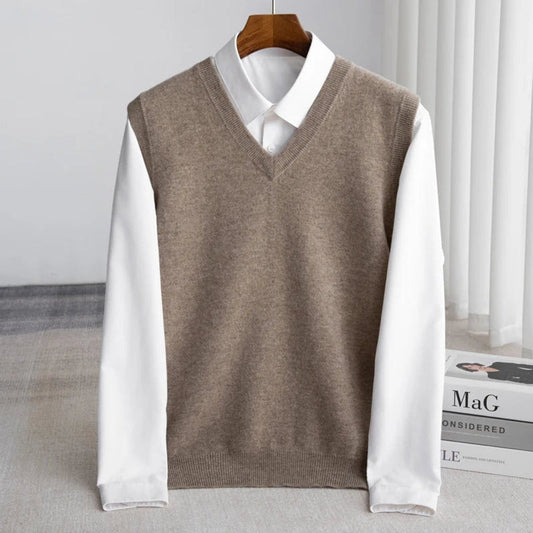 Women's sleeveless V-neck knit sweater vest layered over a white collared shirt