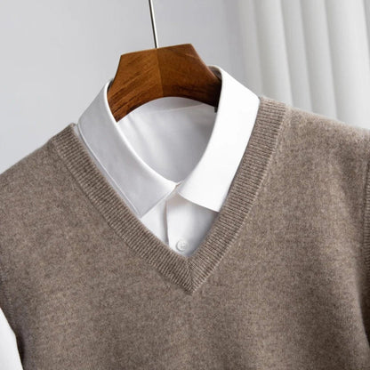 Women's sleeveless V-neck knit sweater vest layered over a white collared shirt