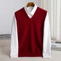 Women's sleeveless V-neck knit sweater vest layered over a white collared shirt