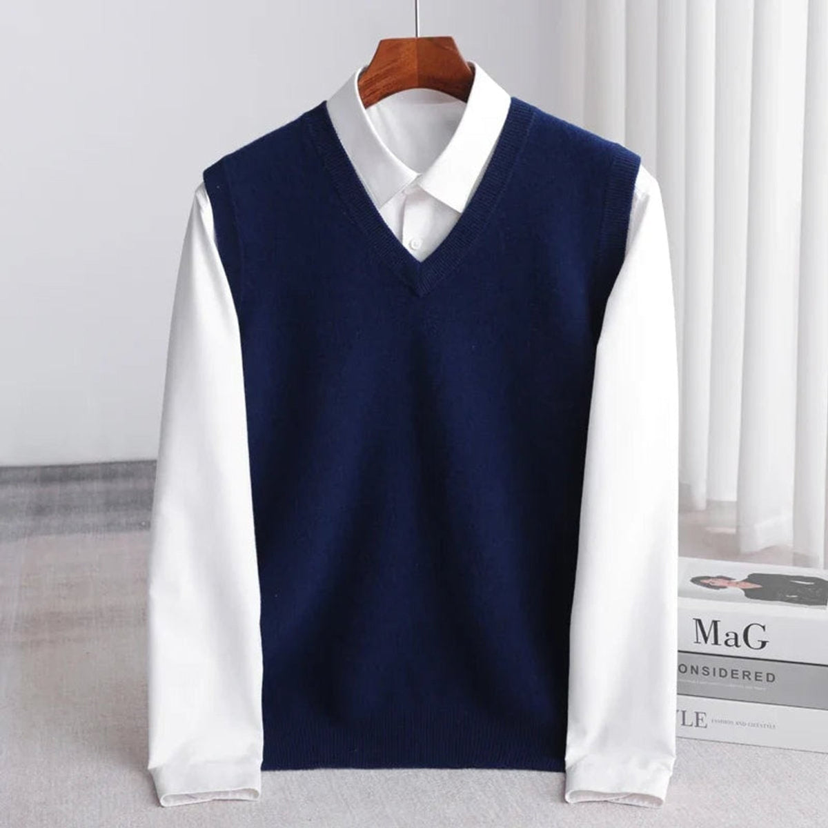 Women's sleeveless V-neck knit sweater vest layered over a white collared shirt