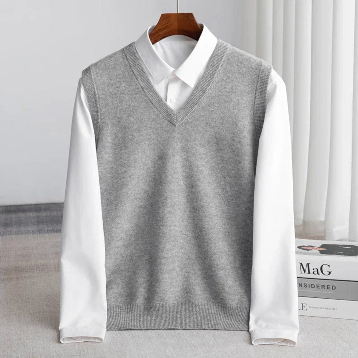 Women's sleeveless V-neck knit sweater vest layered over a white collared shirt