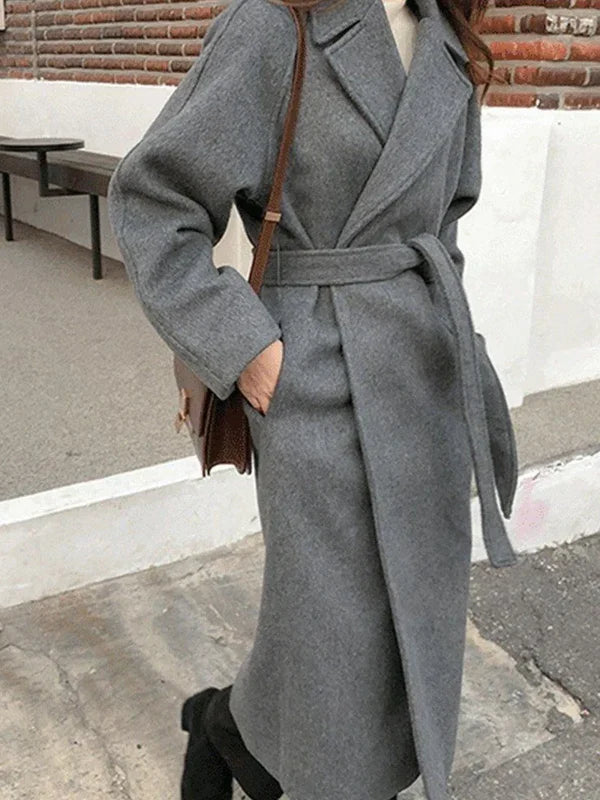 Women's long solid wrap coat with wide lapels and tie belt