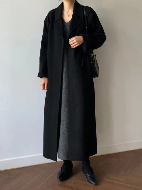 Women's long solid wrap coat with wide lapels and tie belt