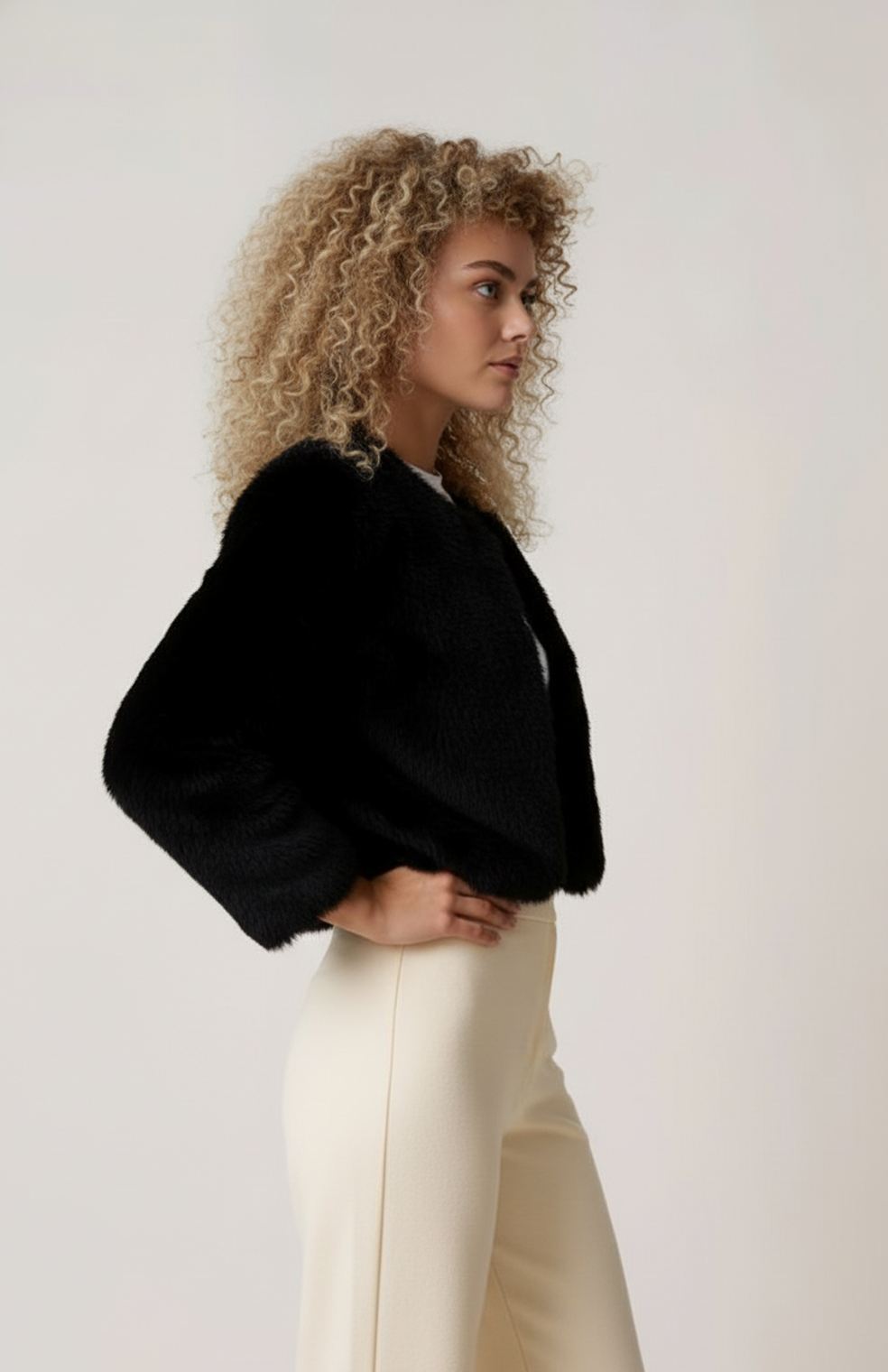 Women's short textured jacket shown in beige and black with long sleeves and an open front
