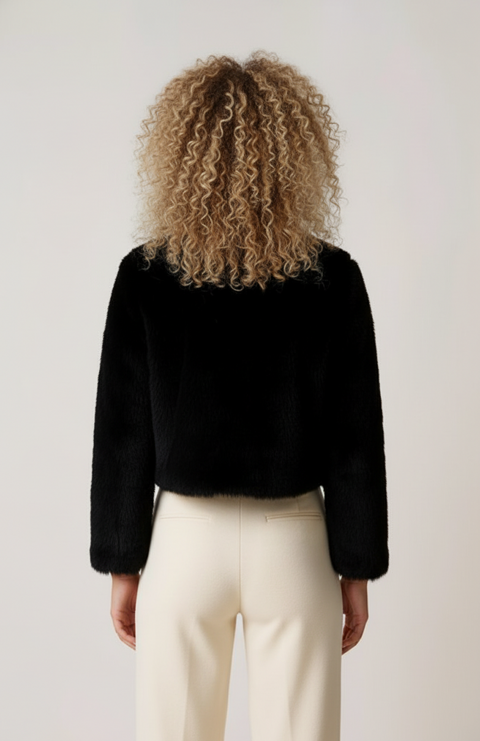 Women's short textured jacket shown in beige and black with long sleeves and an open front