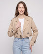Women's beige cropped trench jacket with buckled belt and long sleeves
