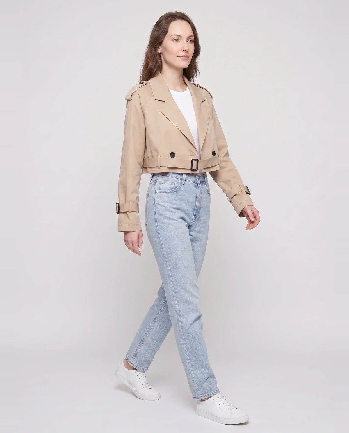 Women's beige cropped trench jacket with buckled belt and long sleeves