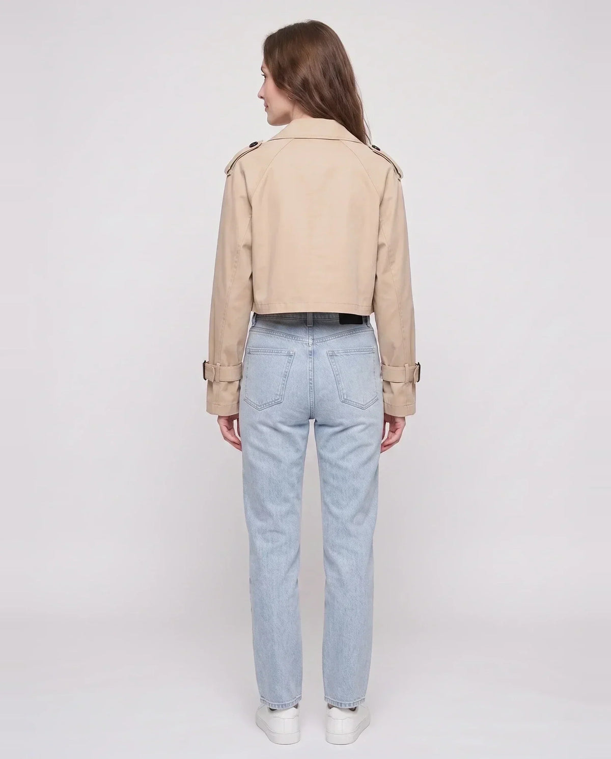 Women's beige cropped trench jacket with buckled belt and long sleeves