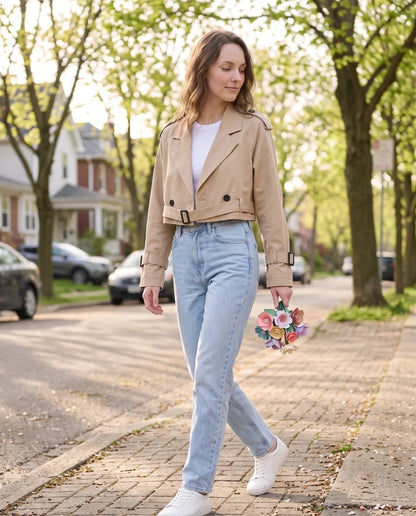 Women's beige cropped trench jacket with buckled belt and long sleeves