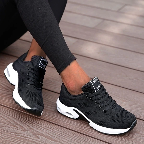 Women's low-top lace-up sneakers with textured panels and sculpted soles