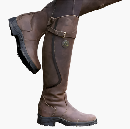 Tall women's riding boots with buckle straps, rounded toes and low heels