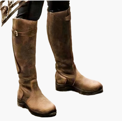 Tall women's riding boots with buckle straps, rounded toes and low heels