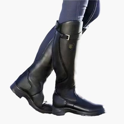 Tall women's riding boots with buckle straps, rounded toes and low heels