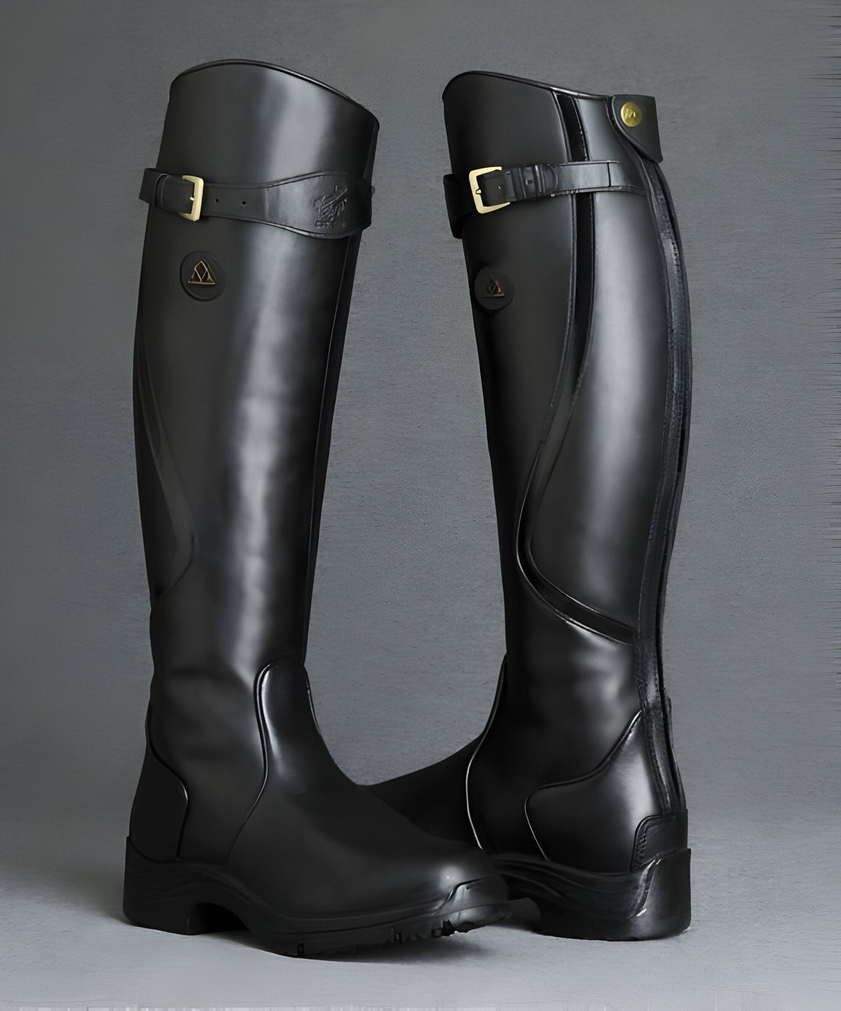 Tall women's riding boots with buckle straps, rounded toes and low heels