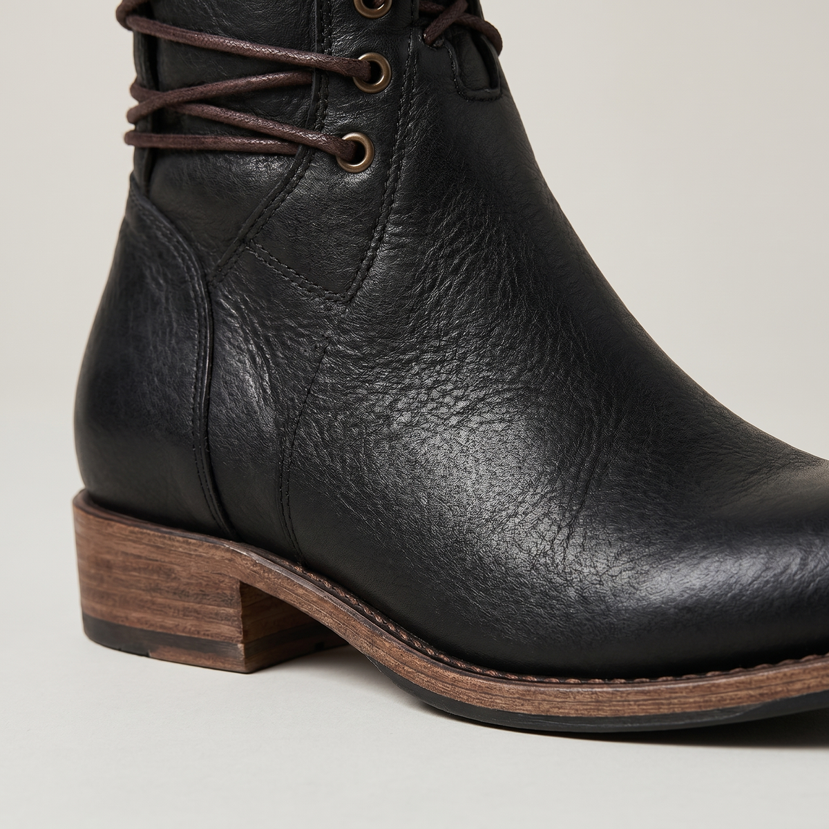 Women's lace-up mid-calf boots with studded cuffs and low block heels
